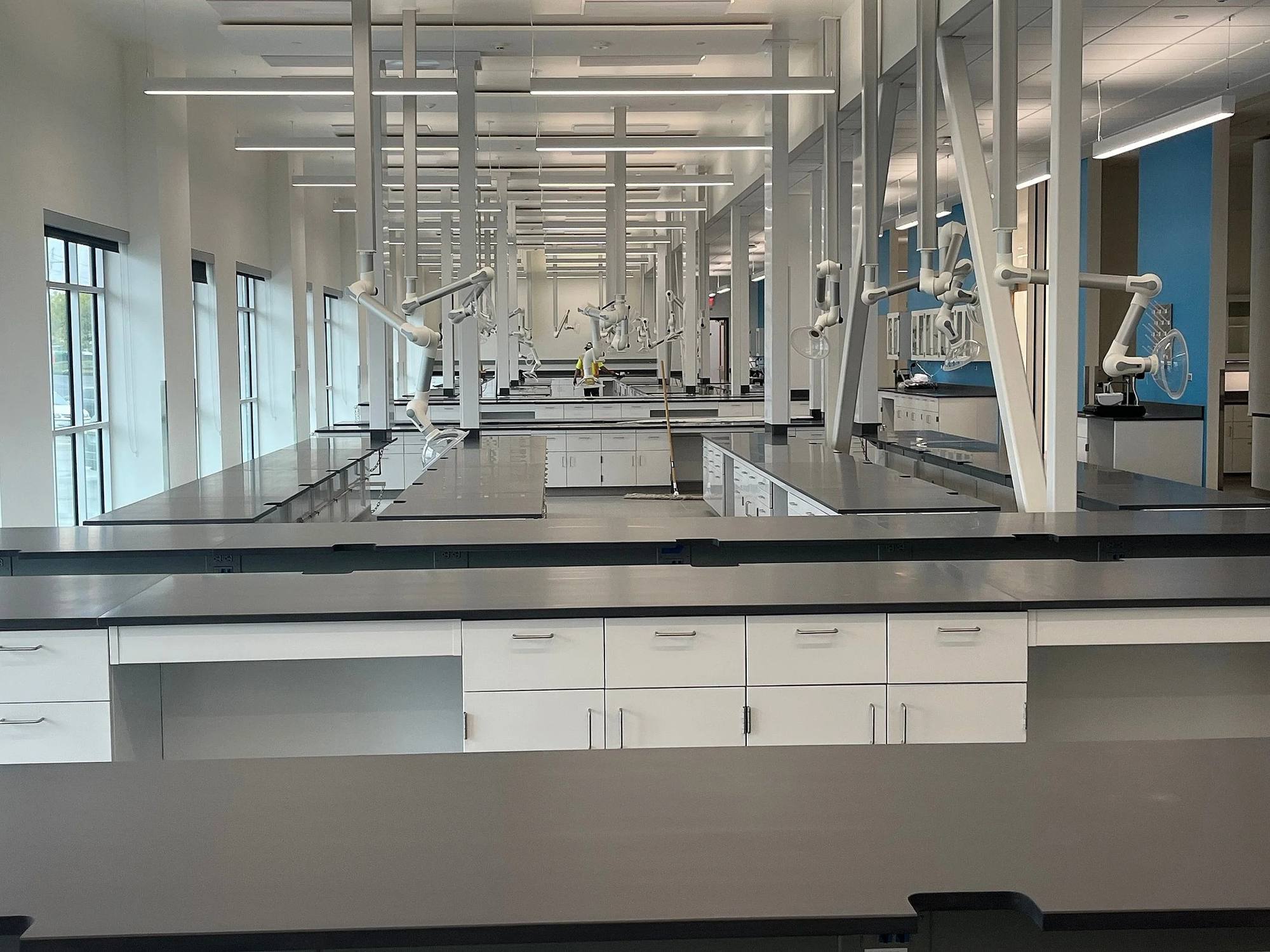 A finished teaching lab with rows of casework and work surfaces